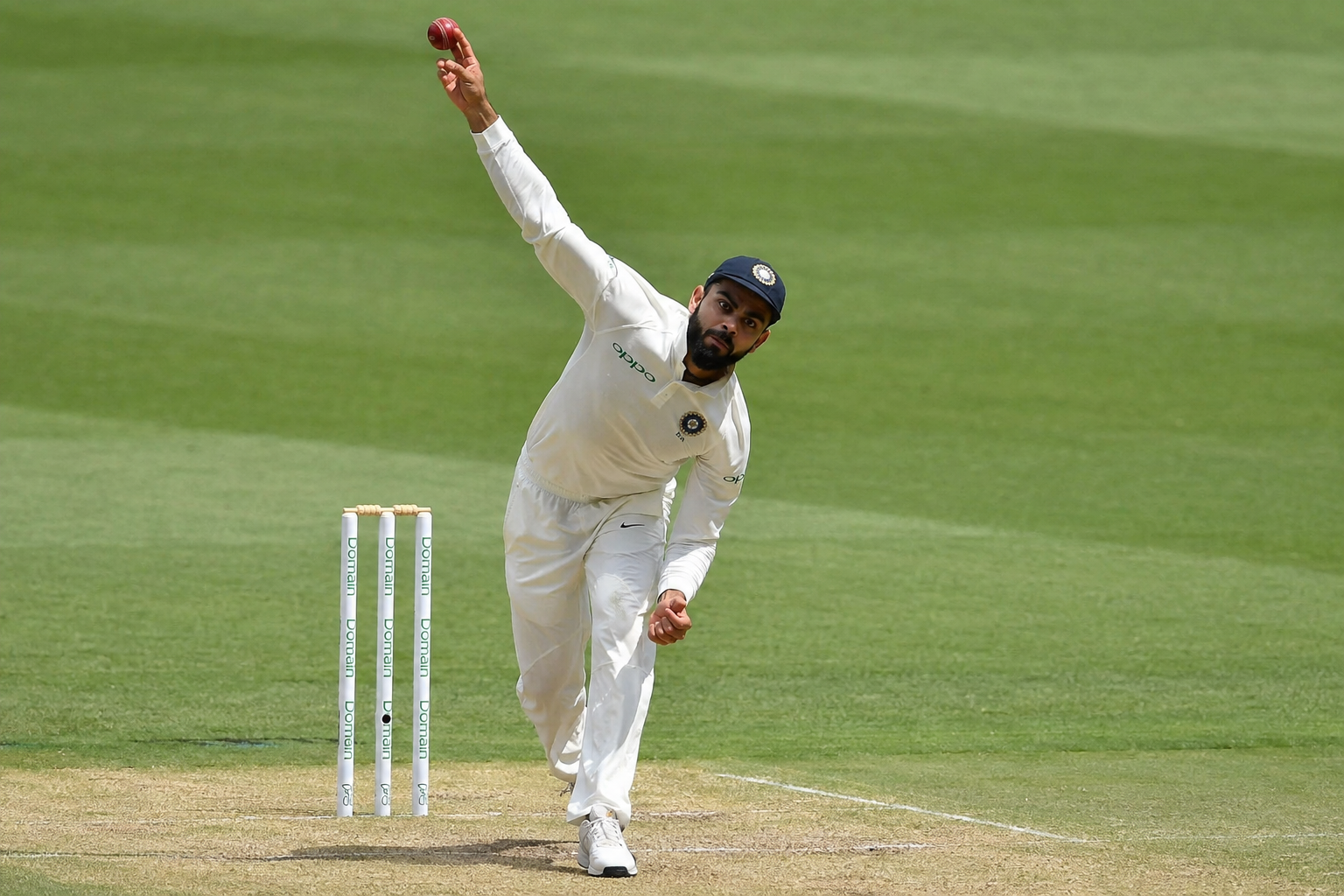 Bowling techniques in cricket leg spin bowler releasing ball with wrist turn at point of delivery .